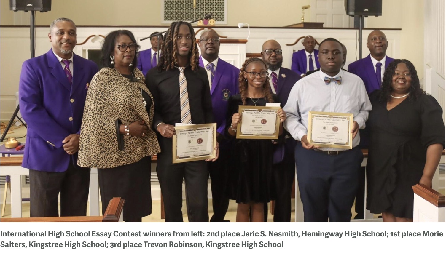 Student essay contest winners with Delta Rho Chapter members and family